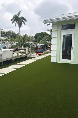 a swimming pool with outdoor seating and garden