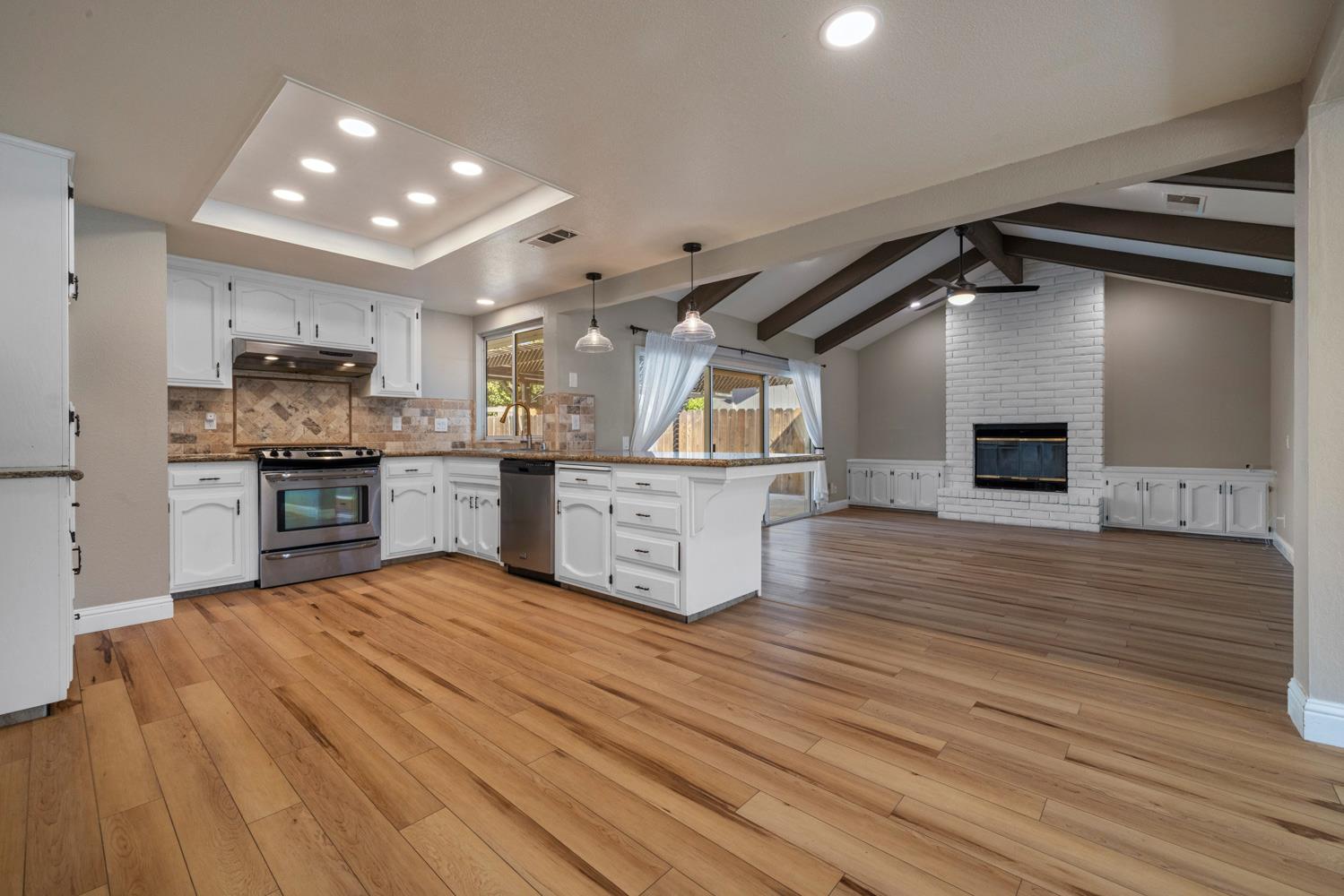 3317 Shamrock Avenue Merced, CA 95340 - Photo 11 of 44 a kitchen with stainless steel appliances granite countertop a sink and cabinets