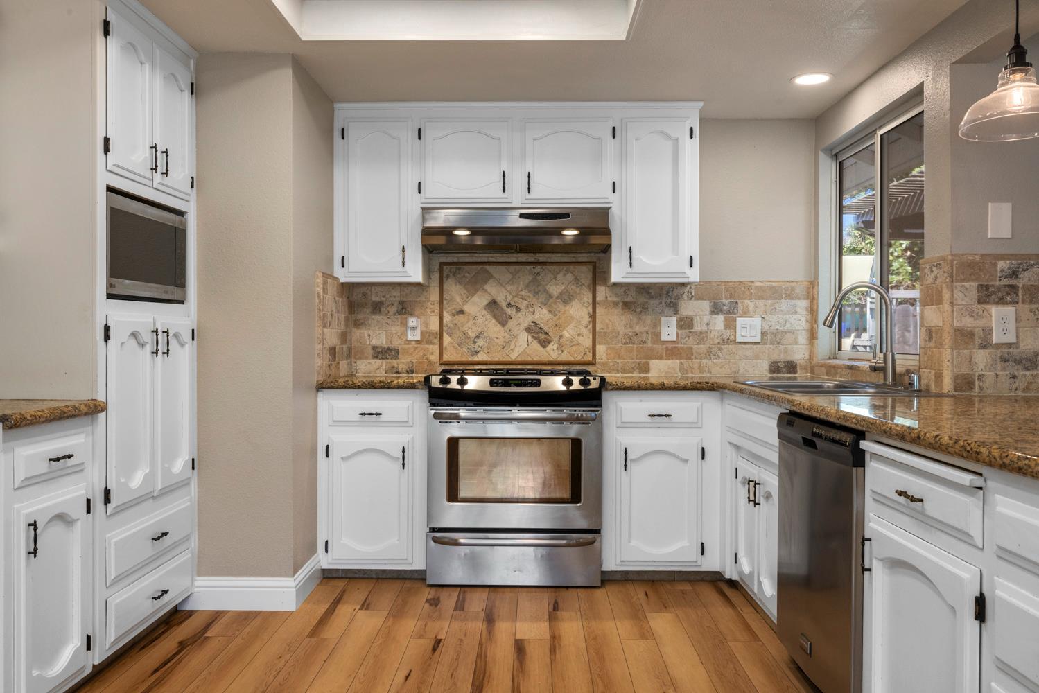 3317 Shamrock Avenue Merced, CA 95340 - Photo 12 of 44 a kitchen with stainless steel appliances granite countertop a stove and a refrigerator