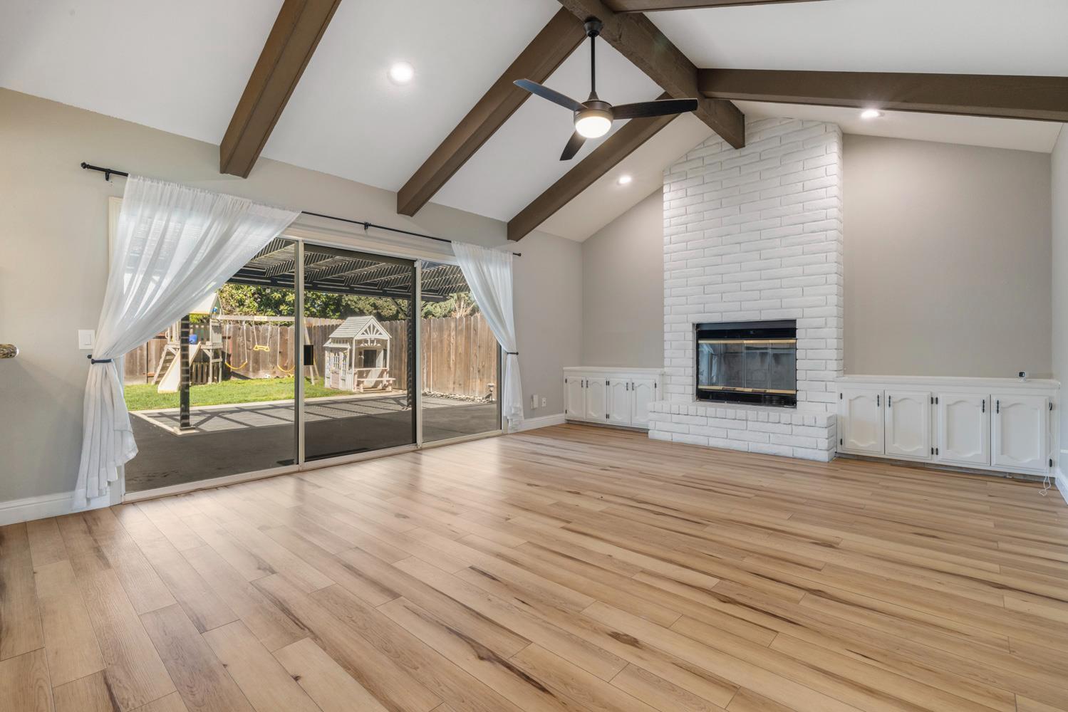 3317 Shamrock Avenue Merced, CA 95340 - Photo 14 of 44 a view of empty room with wooden floor and fireplace