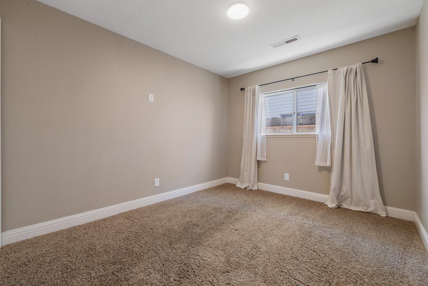 3317 Shamrock Avenue Merced, CA 95340 - Photo 20 of 44 an empty room with windows