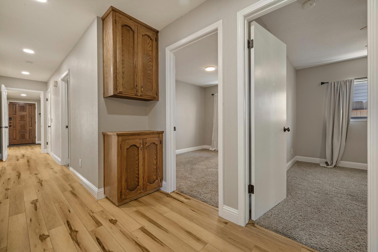 3317 Shamrock Avenue Merced, CA 95340 - Photo 21 of 44 a view of a hallway with wooden floor and staircase