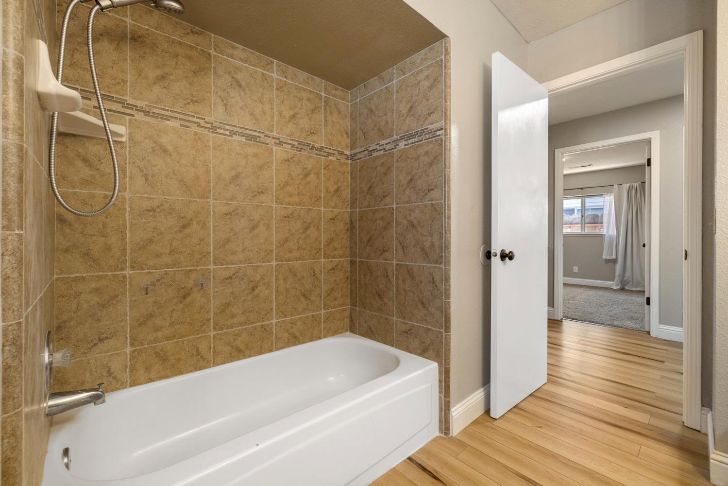 3317 Shamrock Avenue Merced, CA 95340 - Photo 25 of 44 a bathroom with a bathtub and shower