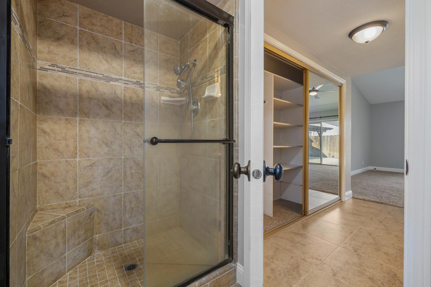 3317 Shamrock Avenue Merced, CA 95340 - Photo 29 of 44 a bathroom with a glass shower door