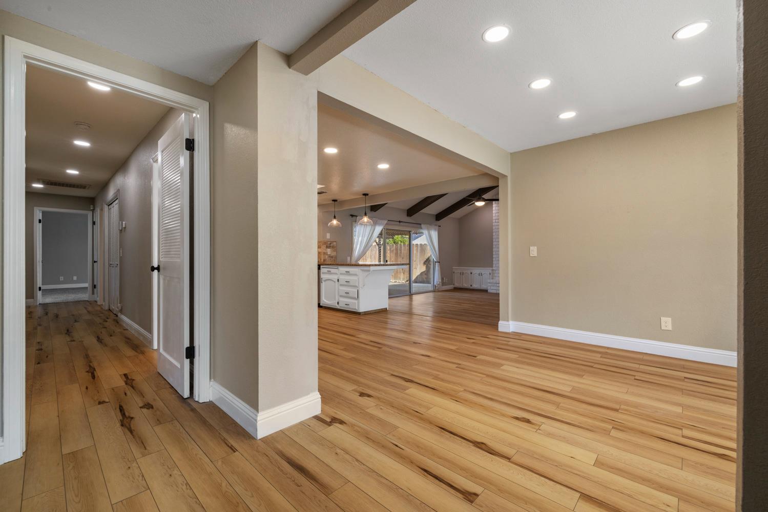 3317 Shamrock Avenue Merced, CA 95340 - Photo 8 of 44 a view of a hallway with wooden floor