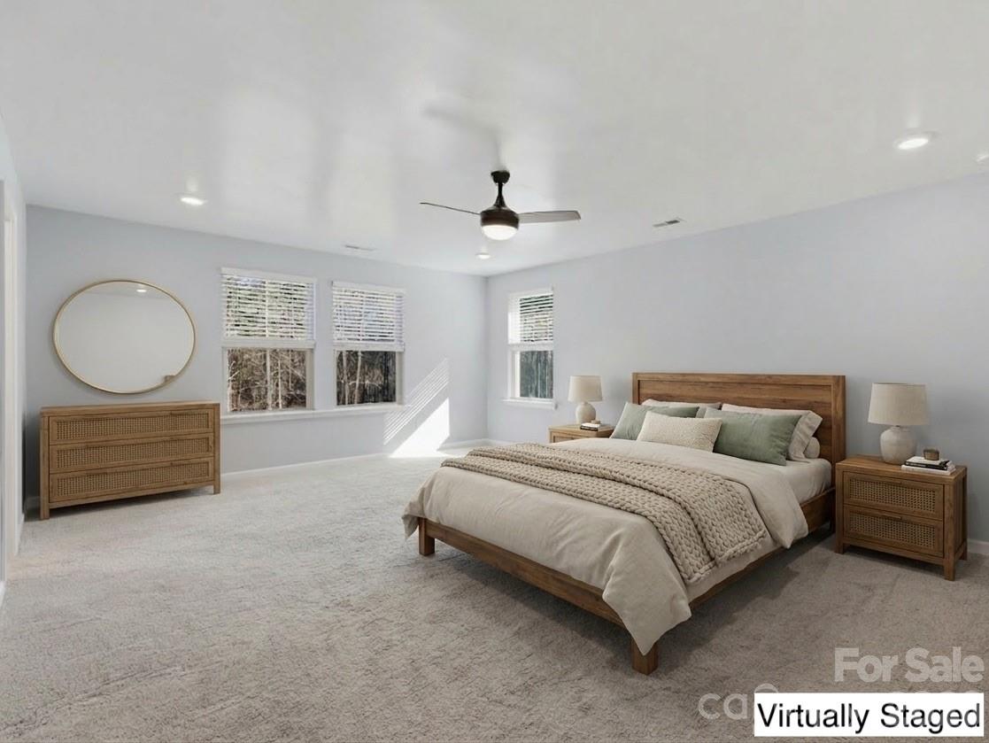 2220 Sussex Road York, SC 29745 - Photo 21 of 42 a spacious bedroom with a bed a dresser and a chandelier