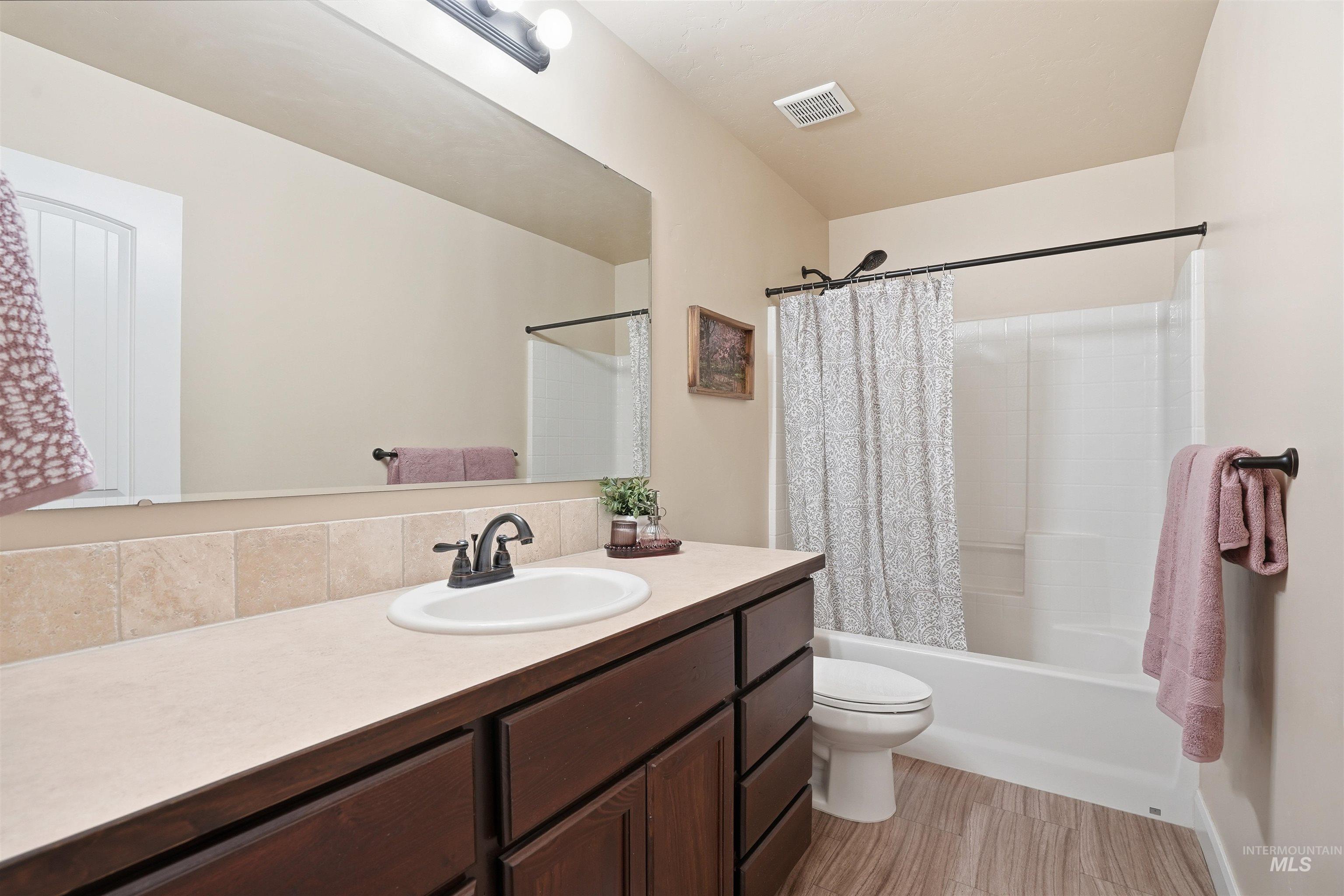 5697 Combermere Drive Eagle, ID 83616 - Photo 24 of 43 Full bathroom featuring shower / bathtub combination with curtain and vanity