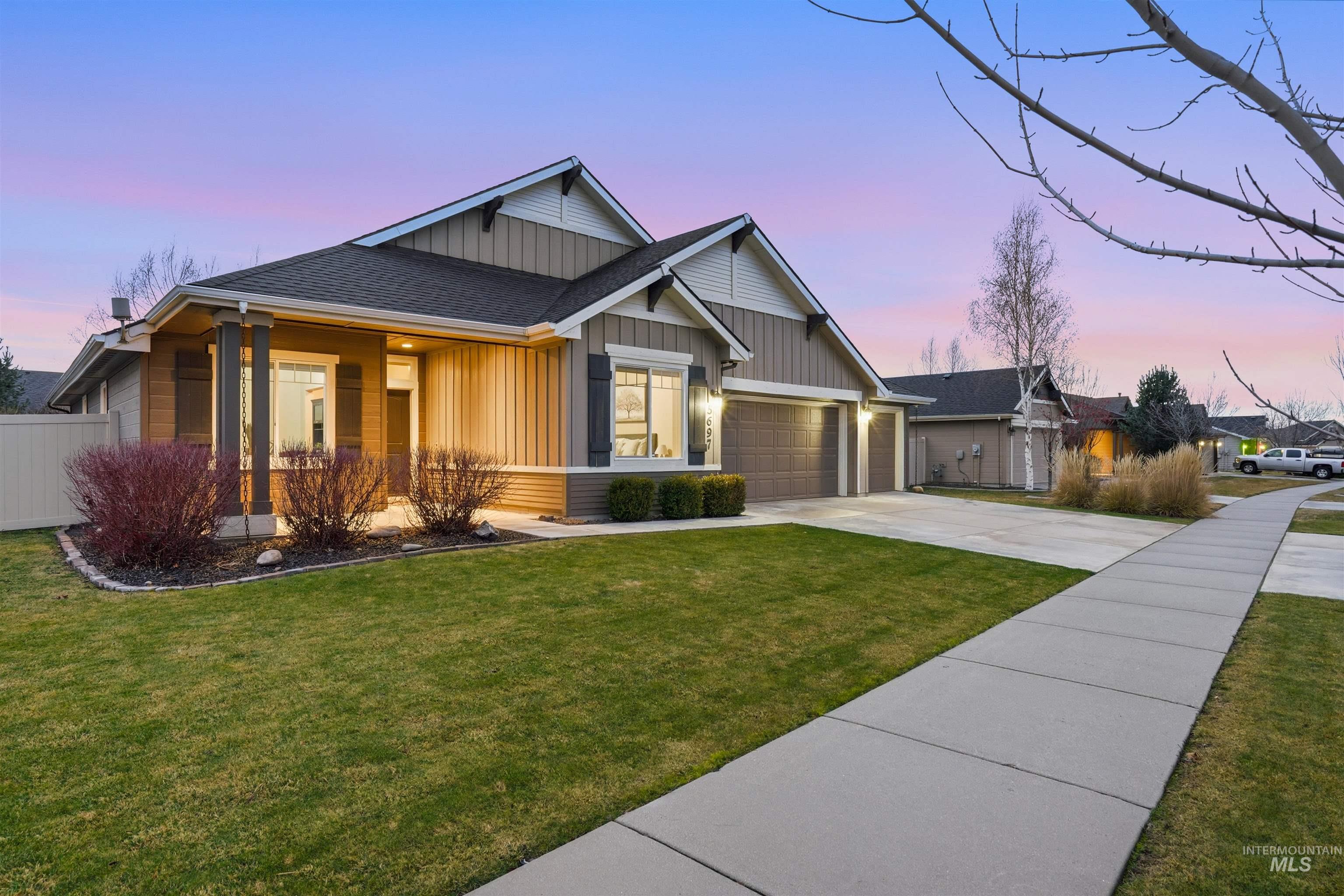 5697 Combermere Drive Eagle, ID 83616 - Photo 3 of 43 Craftsman-style house with driveway, board and batten siding, roof with shingles, an attached garage, and covered porch