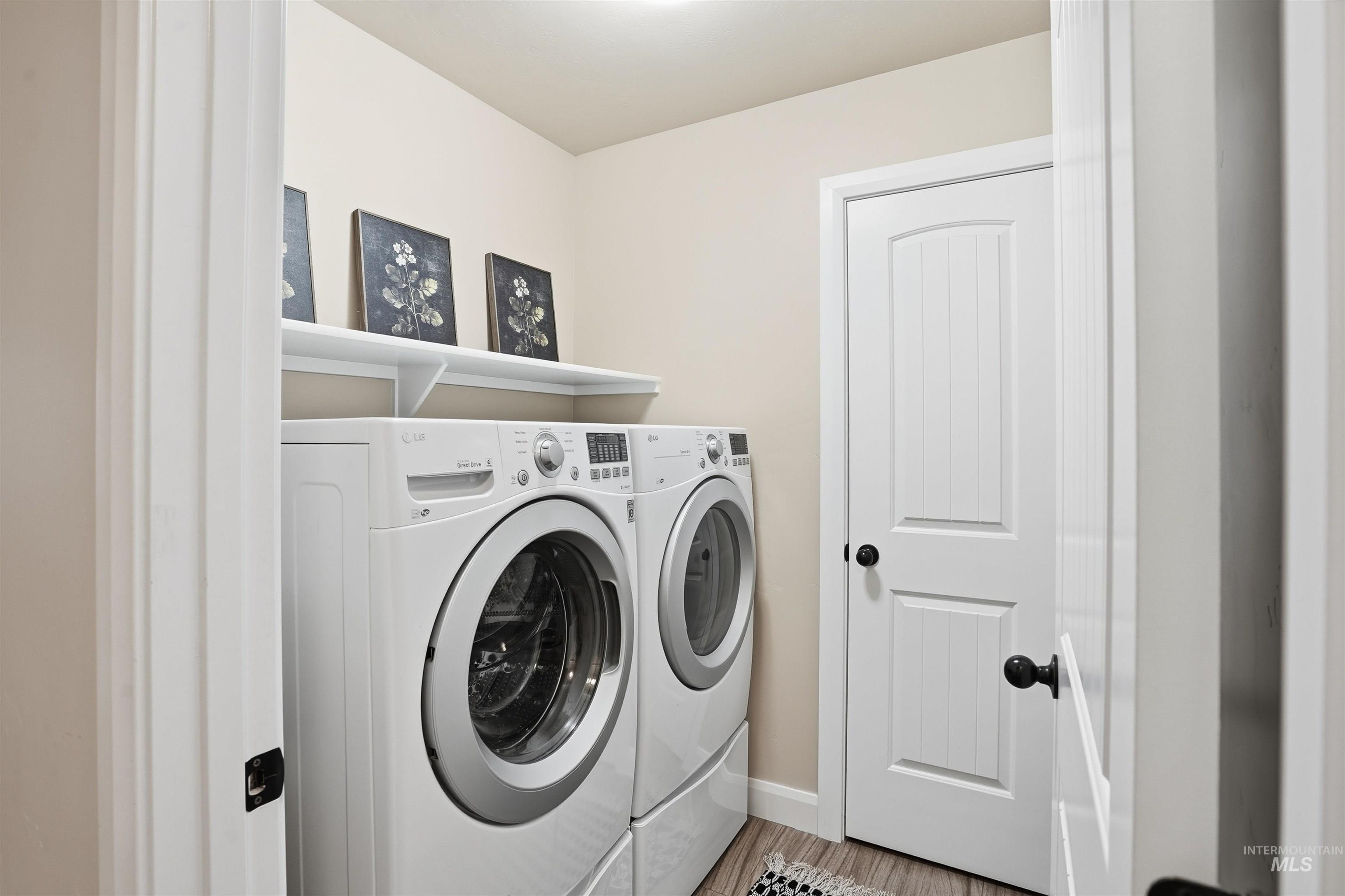 5697 Combermere Drive Eagle, ID 83616 - Photo 31 of 43 Laundry area with washing machine and clothes dryer and wood finished floors