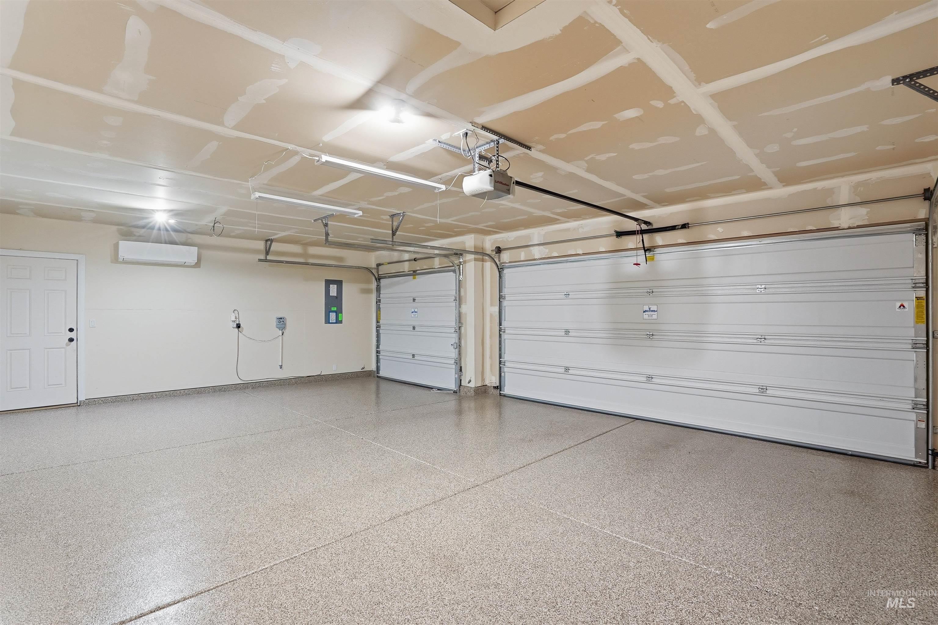 5697 Combermere Drive Eagle, ID 83616 - Photo 32 of 43 Garage featuring an AC wall unit and electric panel