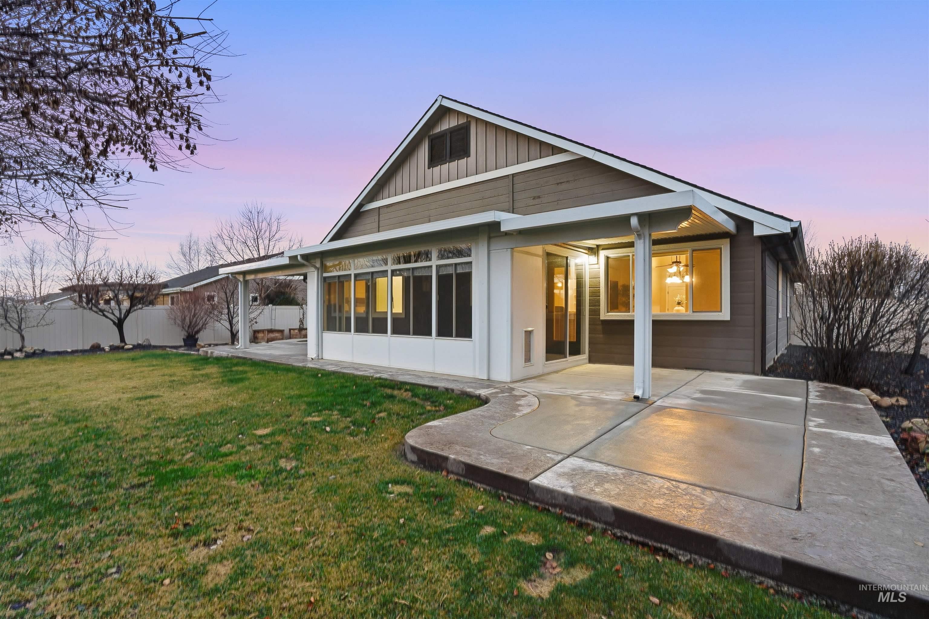 5697 Combermere Drive Eagle, ID 83616 - Photo 37 of 43 Back of property at dusk featuring a patio area and board and batten siding