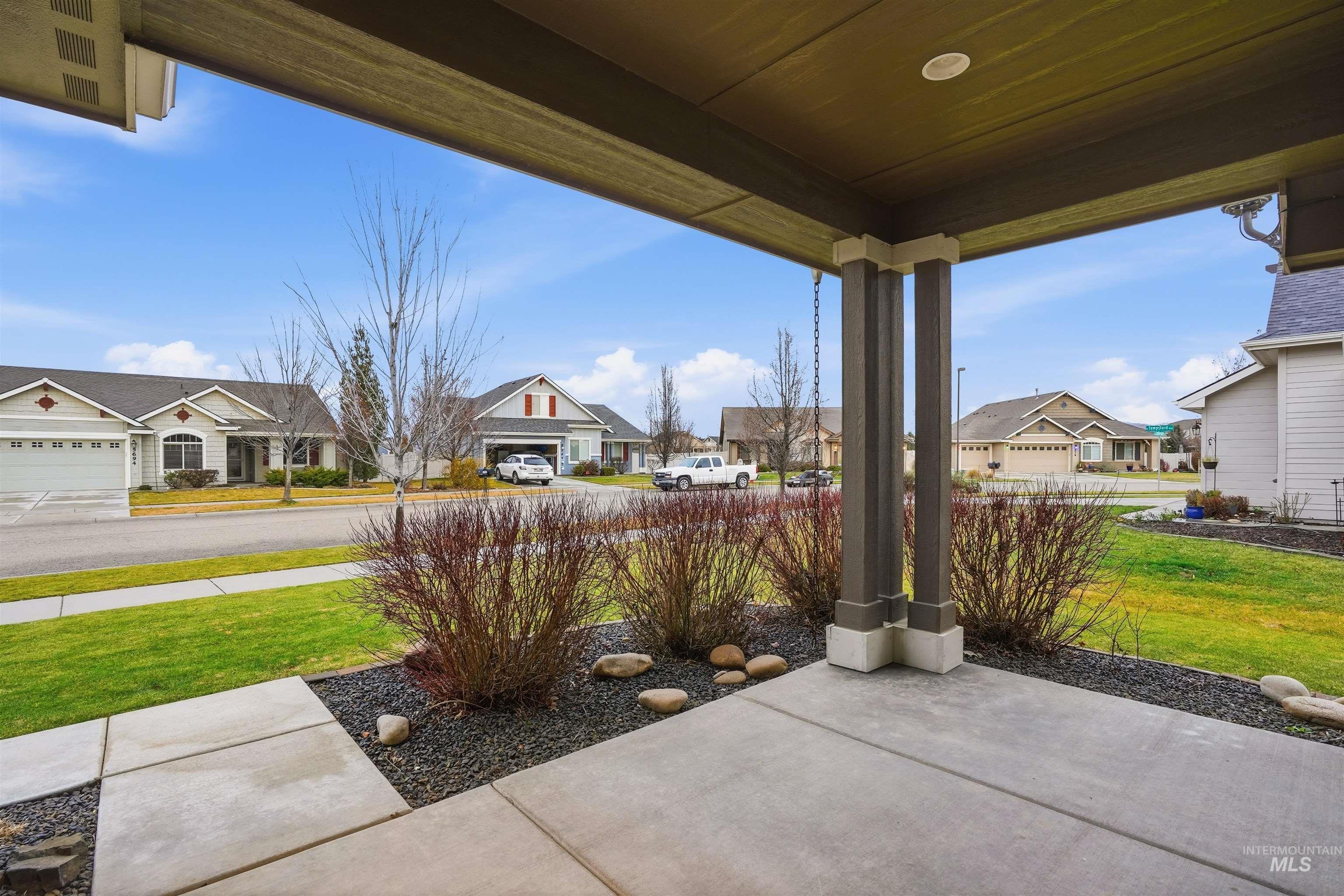 5697 Combermere Drive Eagle, ID 83616 - Photo 39 of 43 Covered porch featuring a lawn and a residential view