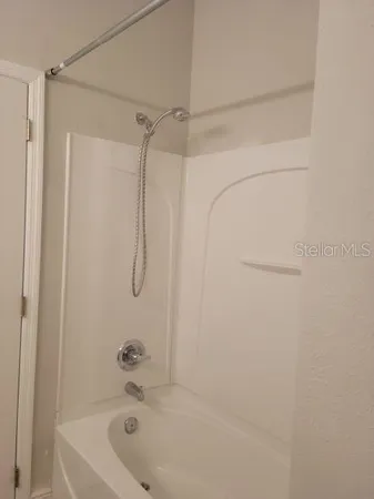 a bathroom with a bath tub with a shower
