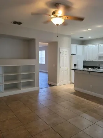 a view of a kitchen with a sink and a refrigerator in it