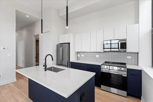 a kitchen with a stove a sink and a microwave