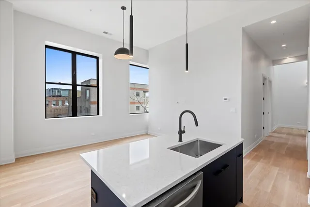 a kitchen with a sink a counter space and a window