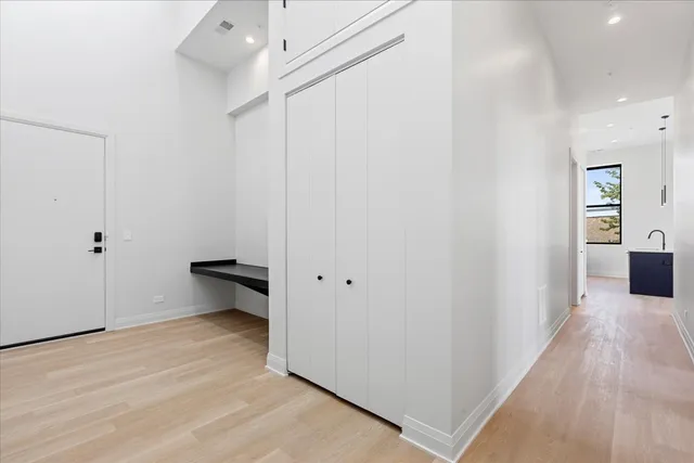 a view of a room with wooden floor and cabinet