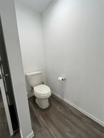 a white toilet sitting next to a white cabinet