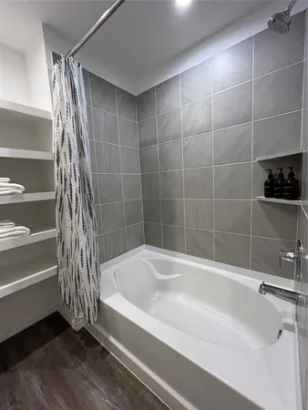 a bathroom with a bathtub and a shower