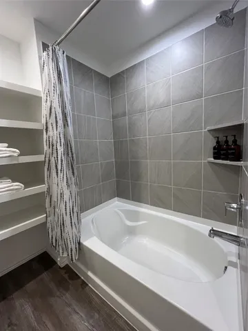 a bathroom with a bathtub and a shower