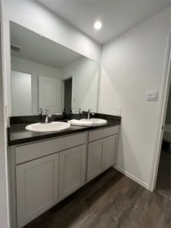 a bathroom with a double vanity sink and mirror