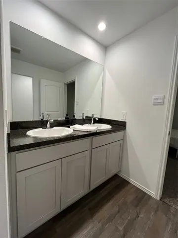 a bathroom with a double vanity sink and mirror