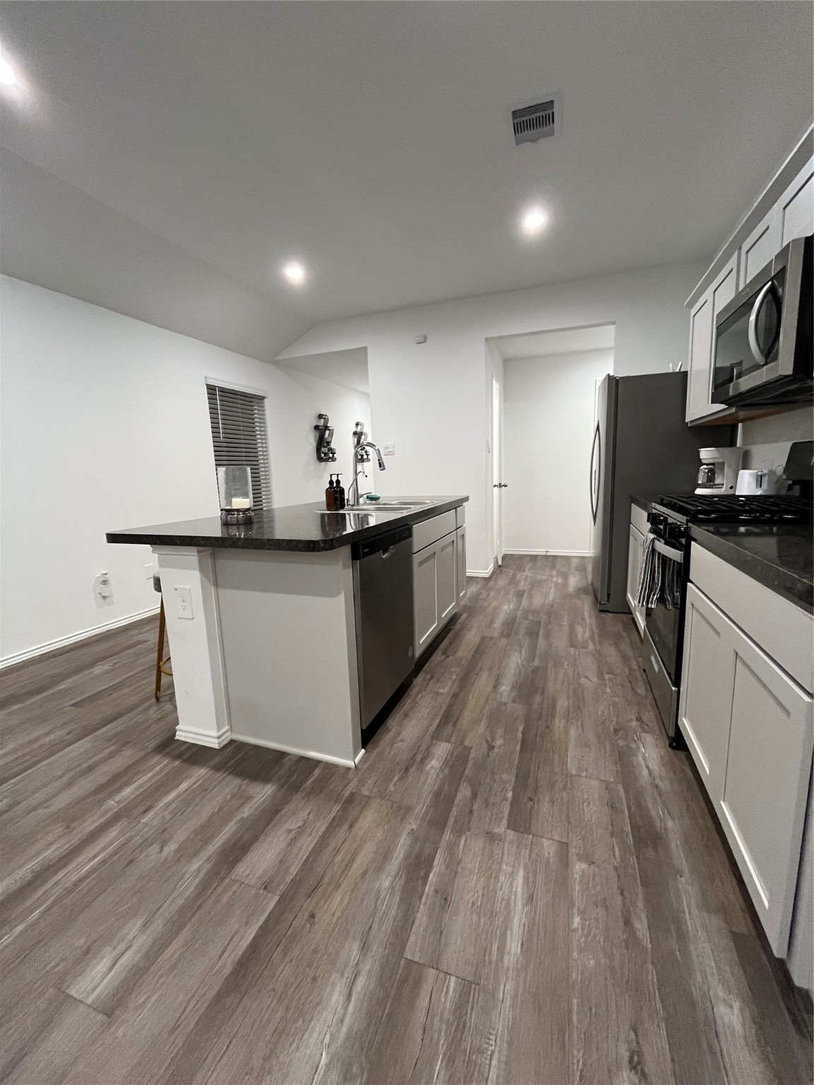 5446 Wyndham Ridge Ln Spring Spring, TX 77373 - Photo 16 of 24 a kitchen with stainless steel appliances a stove top oven a sink dishwasher and a refrigerator