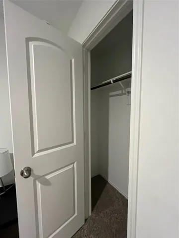 a bedroom with a bed and a night stand