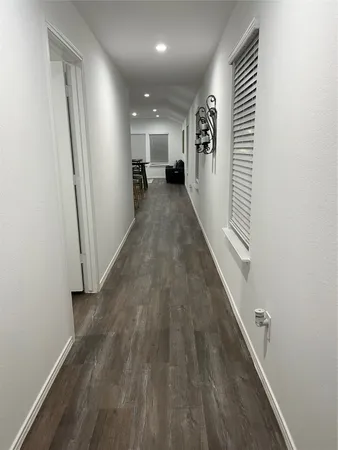 an entryway in a hall with wooden floor