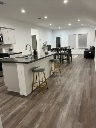 a kitchen with stainless steel appliances granite countertop a stove top oven a sink a counter space and cabinets