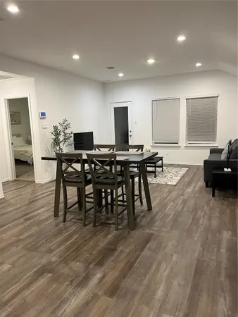 a view of a a dining room with furniture window and wooden floor