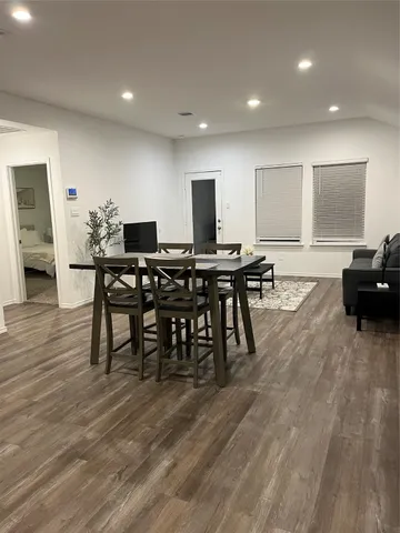 a view of a a dining room with furniture window and wooden floor