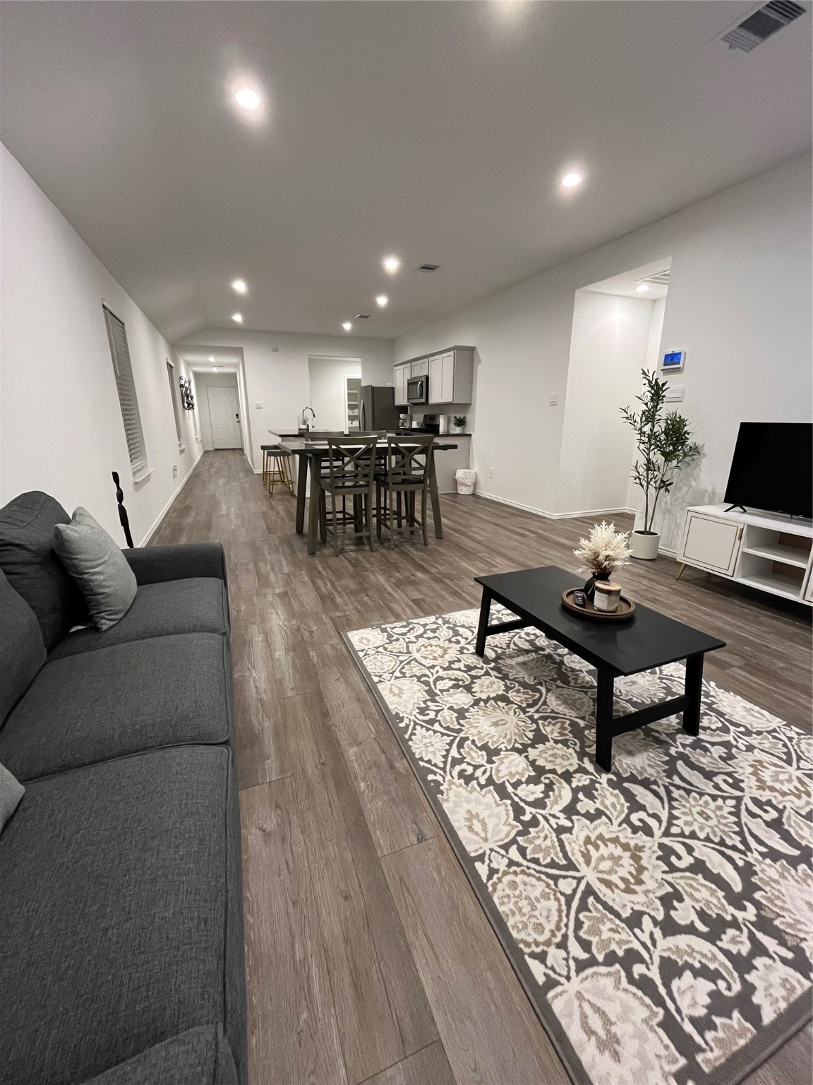5446 Wyndham Ridge Ln Spring Spring, TX 77373 - Photo 8 of 24 a living room with furniture a table and kitchen view