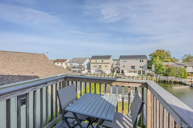 a view of a balcony with wooden chairs