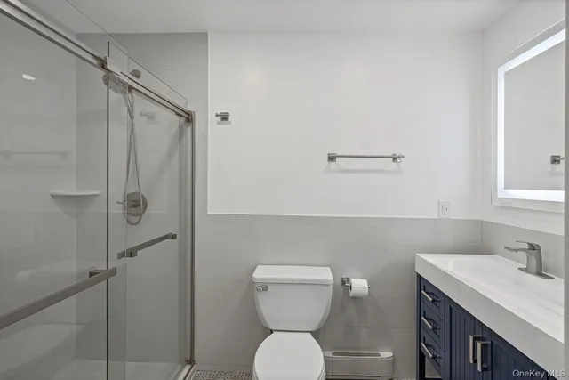 a bathroom with a toilet a sink and mirror