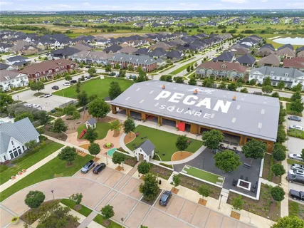 an aerial view of residential houses with outdoor space and a lake view