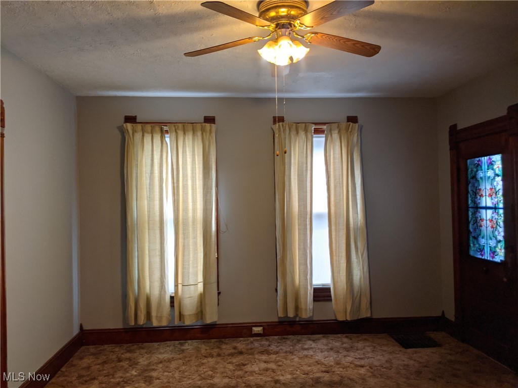 70 Center Road Bedford, OH 44146 - Photo 7 of 18 1st floor unit Spare room featuring carpet flooring and ceiling fan