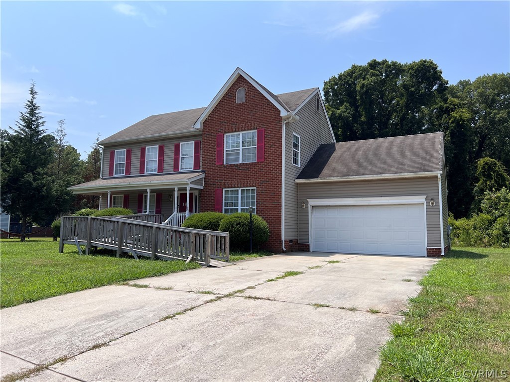 3360 Denise Road Petersburg, VA 23805 - Photo 2 of 22 a front view of a house with a yard and garage