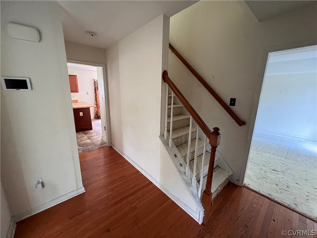 3360 Denise Road Petersburg, VA 23805 - Photo 4 of 22 a view of a hallway with wooden floor and stairs
