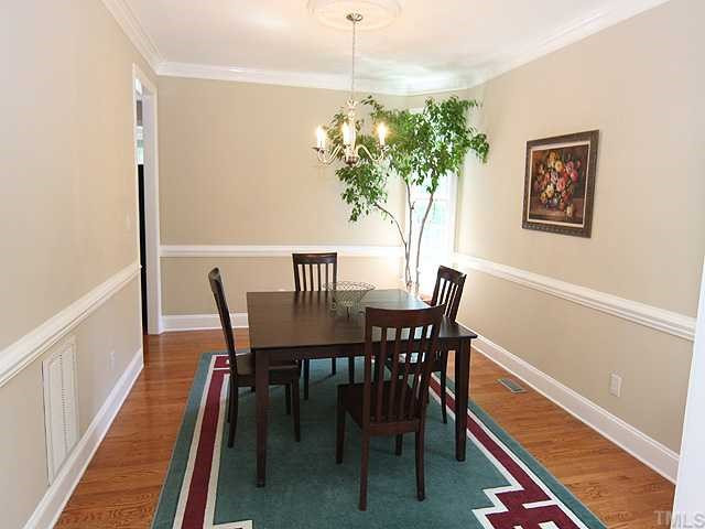 8905 Wildwood Links Raleigh, NC 27613 - Photo 5 of 11 Spacious Dining Room with Hardwoods, Chair Rail and Crown Molding. Dining Room