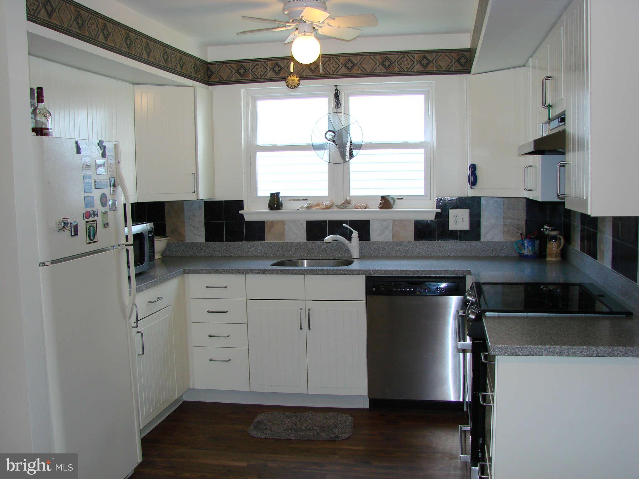 301 Laburnum Road Edgewood, MD 21040 - Photo 8 of 29 a kitchen with granite countertop white cabinets white appliances a sink and a window
