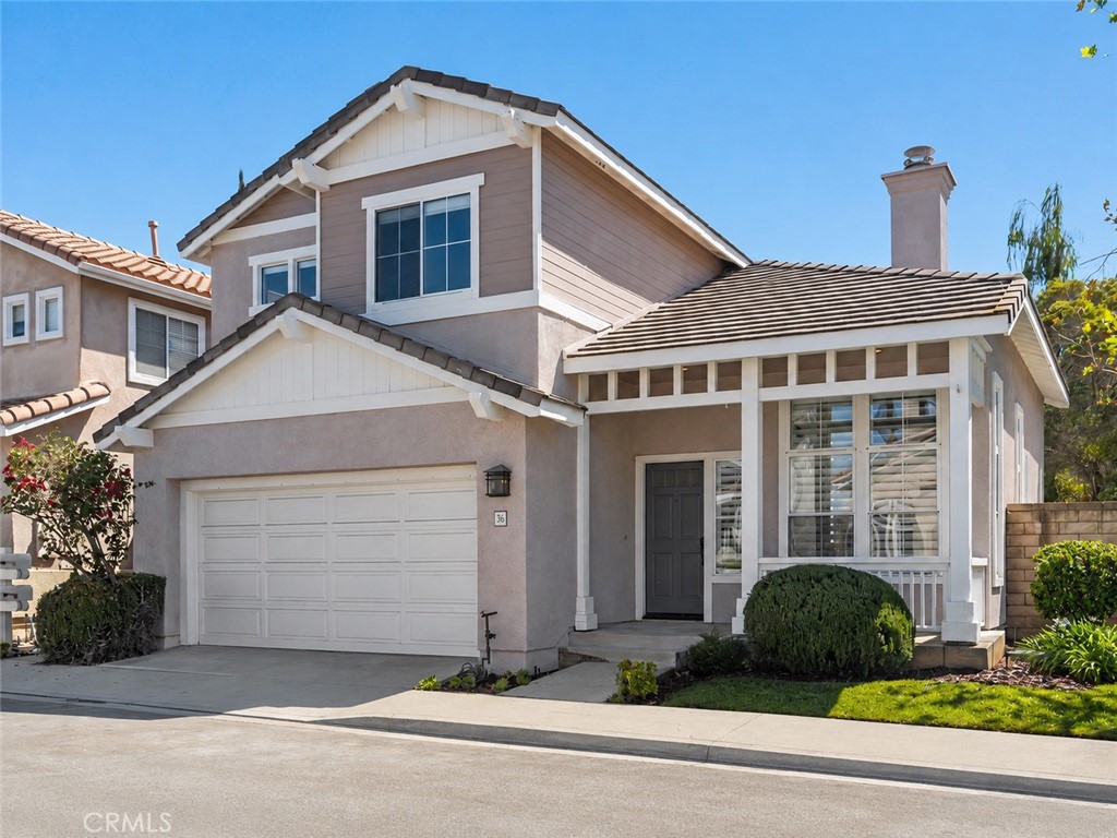 56 Acorn Ridge Rancho Santa Margarita, CA 92688 - Photo 1 of 57 Exterior: Two-story home with an attached two-car garage, covered entry, contrasting exterior finishes, and neatly maintained front landscaping.