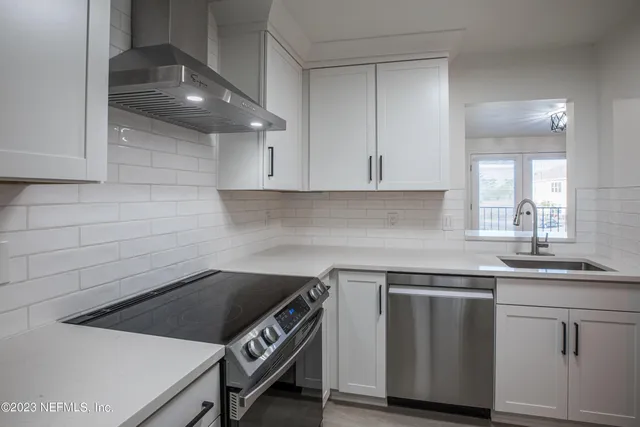 a kitchen with a sink cabinets and stainless steel appliances