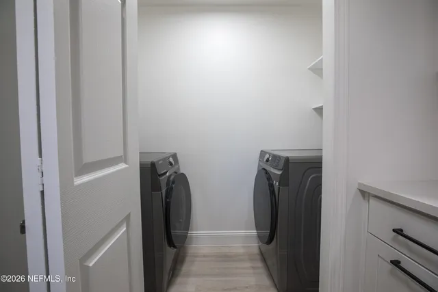 a view of a closet and a mirror