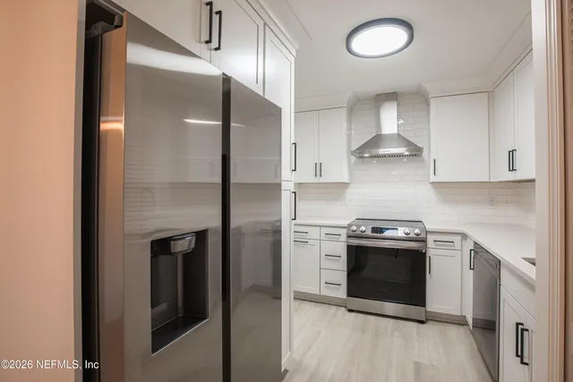 a kitchen with stainless steel appliances granite countertop a stove and a refrigerator