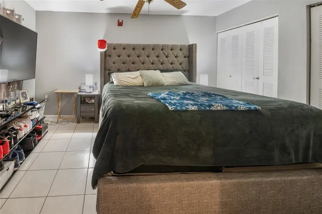 a bedroom with a bed and a lamp on the dresser