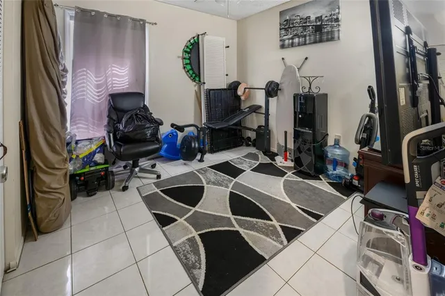 a view of a workspace with furniture and a flat screen tv