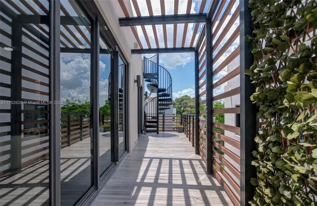 a view of a balcony with wooden floor