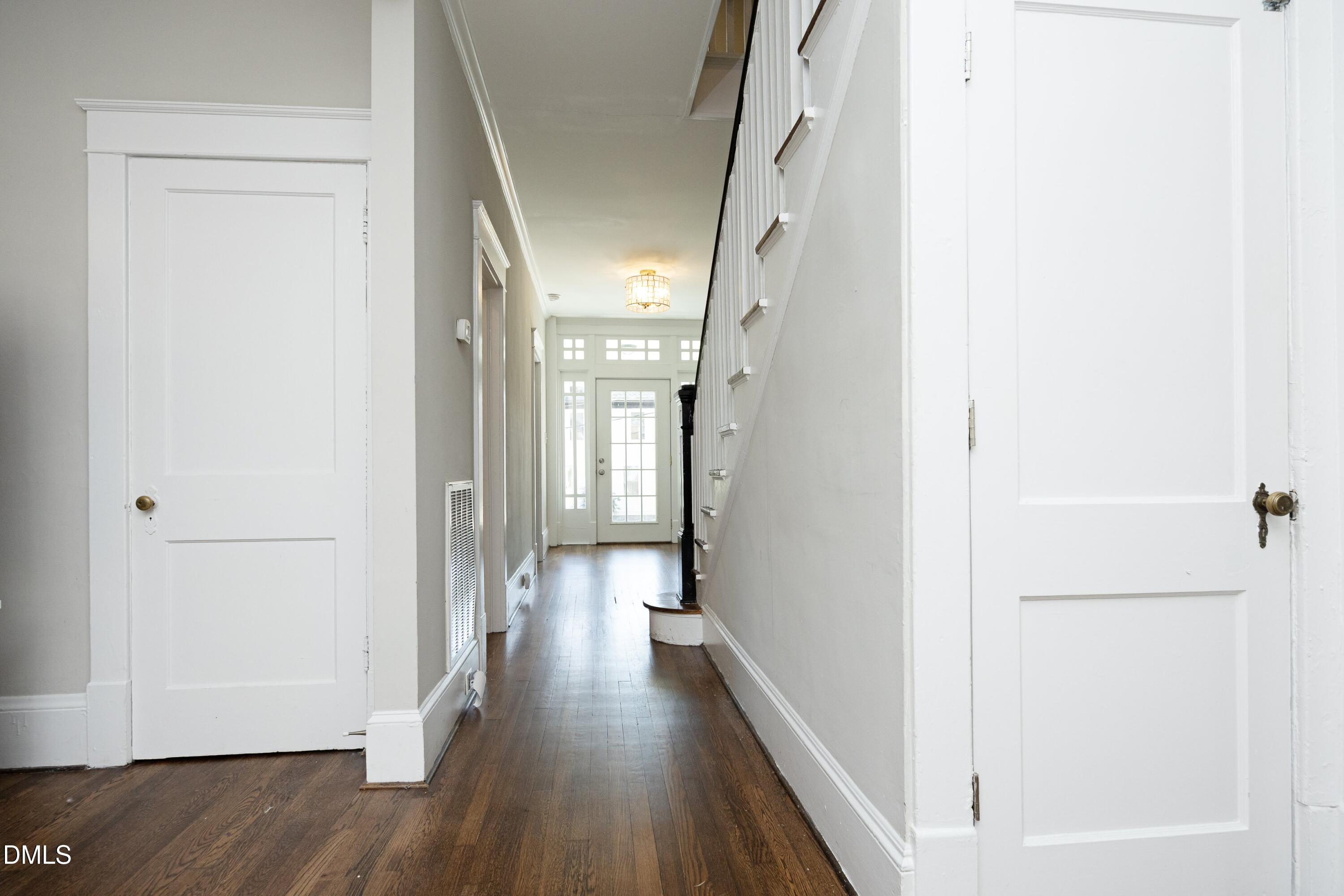 206 Ashe Avenue Raleigh, NC 27605 - Photo 11 of 37 a view of a hallway with wooden floor