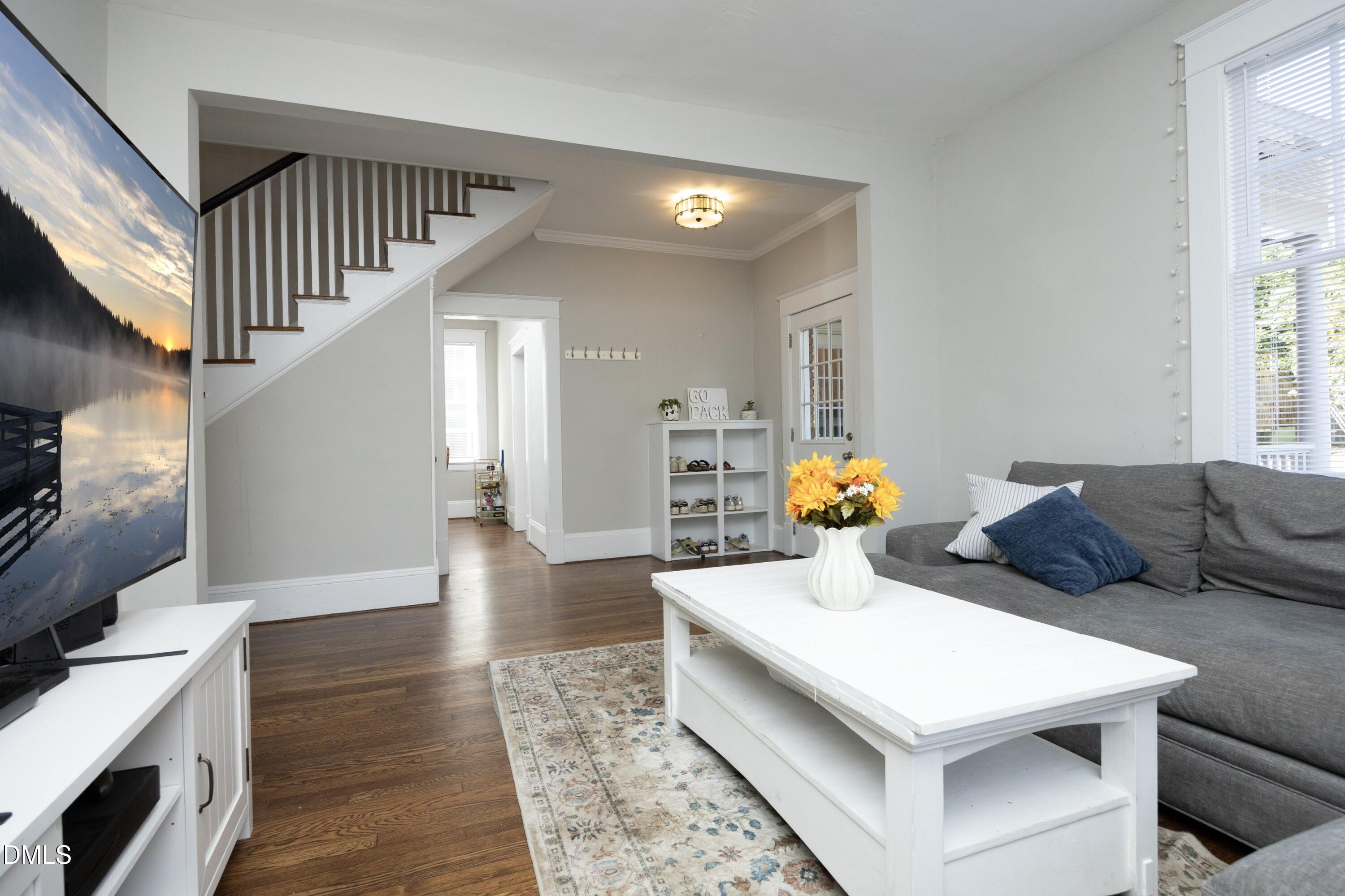 206 Ashe Avenue Raleigh, NC 27605 - Photo 13 of 37 a living room with furniture and a chandelier